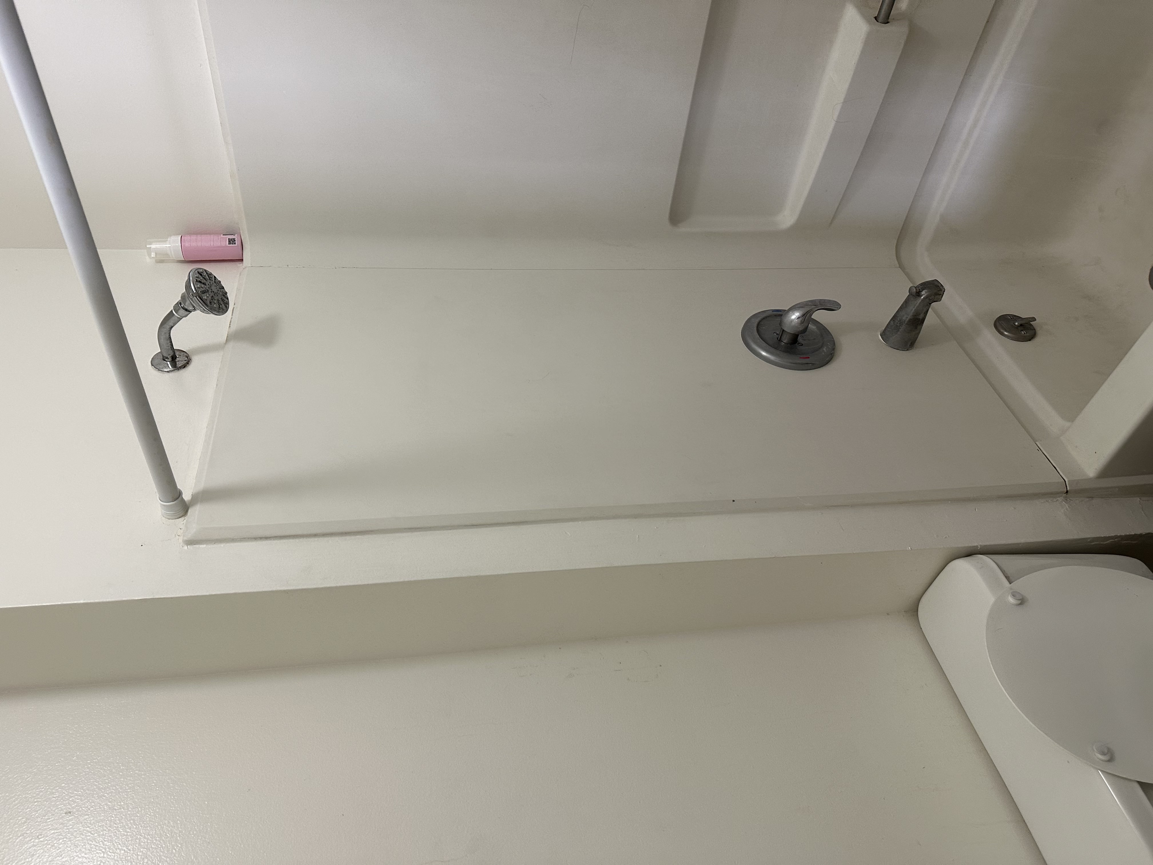 Bathroom with toilet and bathing tub / shower combination
