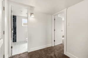 Hall with light carpet and light marble finish floors