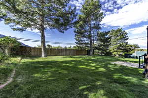 Fenced backyard featuring a patio