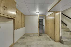 Finished below grade area with stairs and baseboards