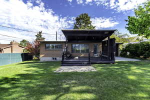 Rear view of house with brick siding and a deck