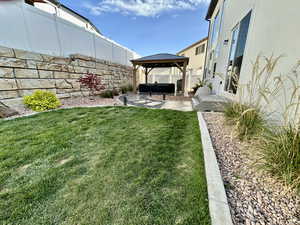 Fenced backyard featuring a gazebo, and a patio area