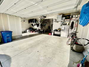 Garage with stainless steel fridge with ice dispenser