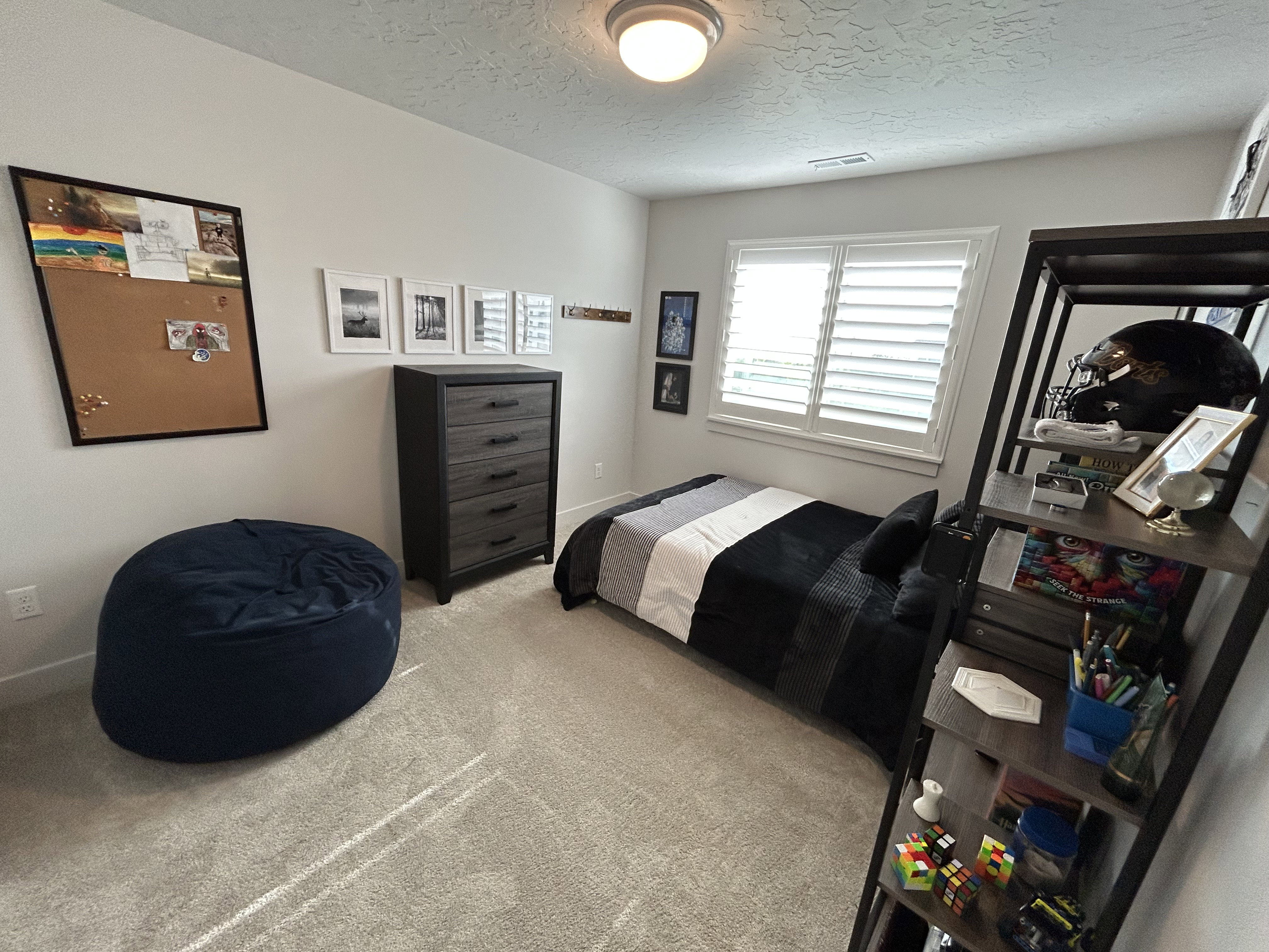 Bedroom with light carpet and a textured ceiling