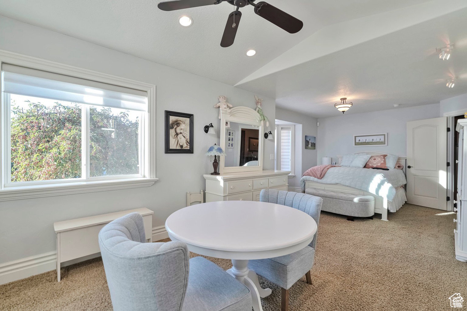 Dining room with lofted ceiling, a ceiling fan, recessed lighting, light colored carpet, and plenty of natural light