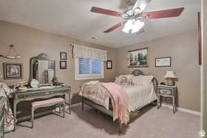Bedroom with light carpet and a ceiling fan