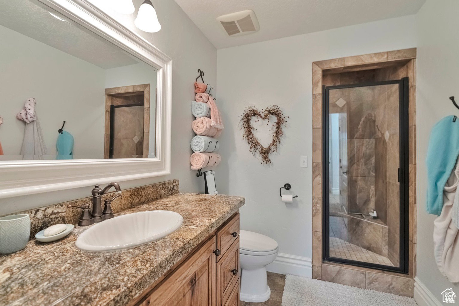 Full bathroom with a stall shower and vanity