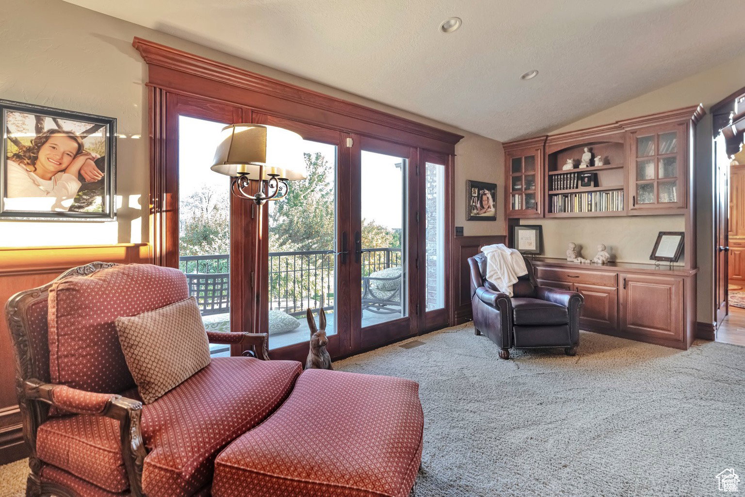 Sitting room with lofted ceiling, french doors, light carpet, wainscoting, and recessed lighting