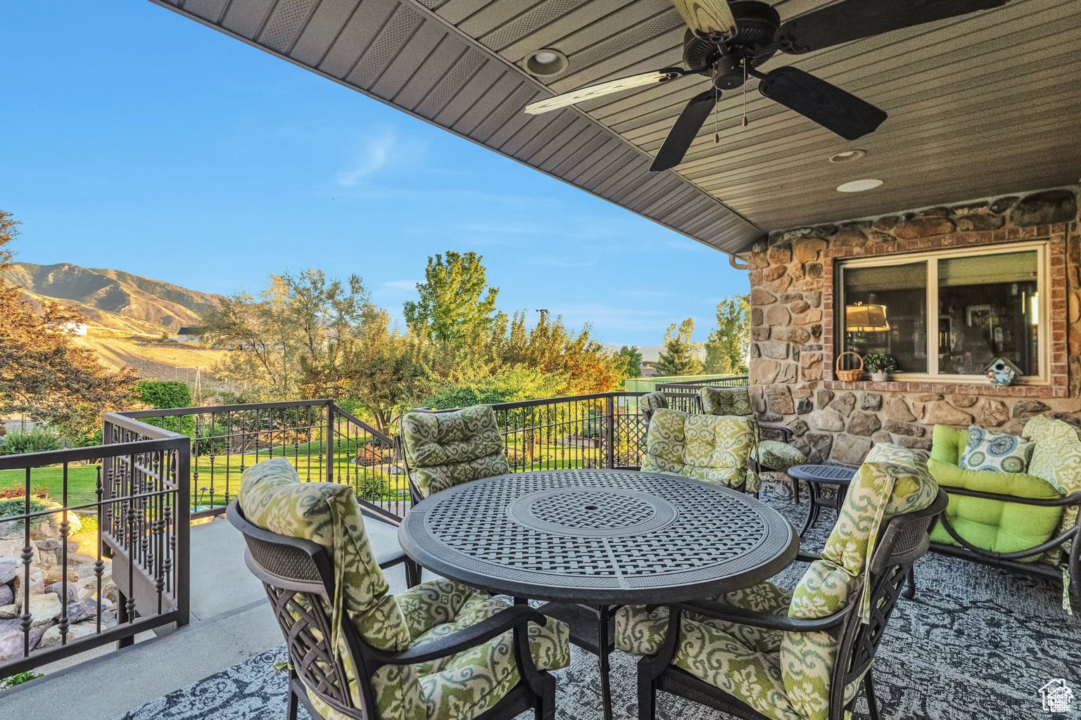 Balcony with outdoor dining area and ceiling fan