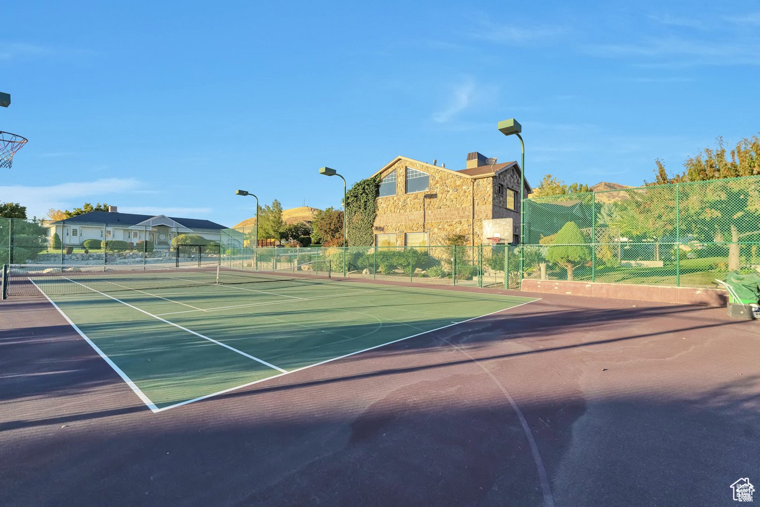 View of tennis court featuring community basketball court