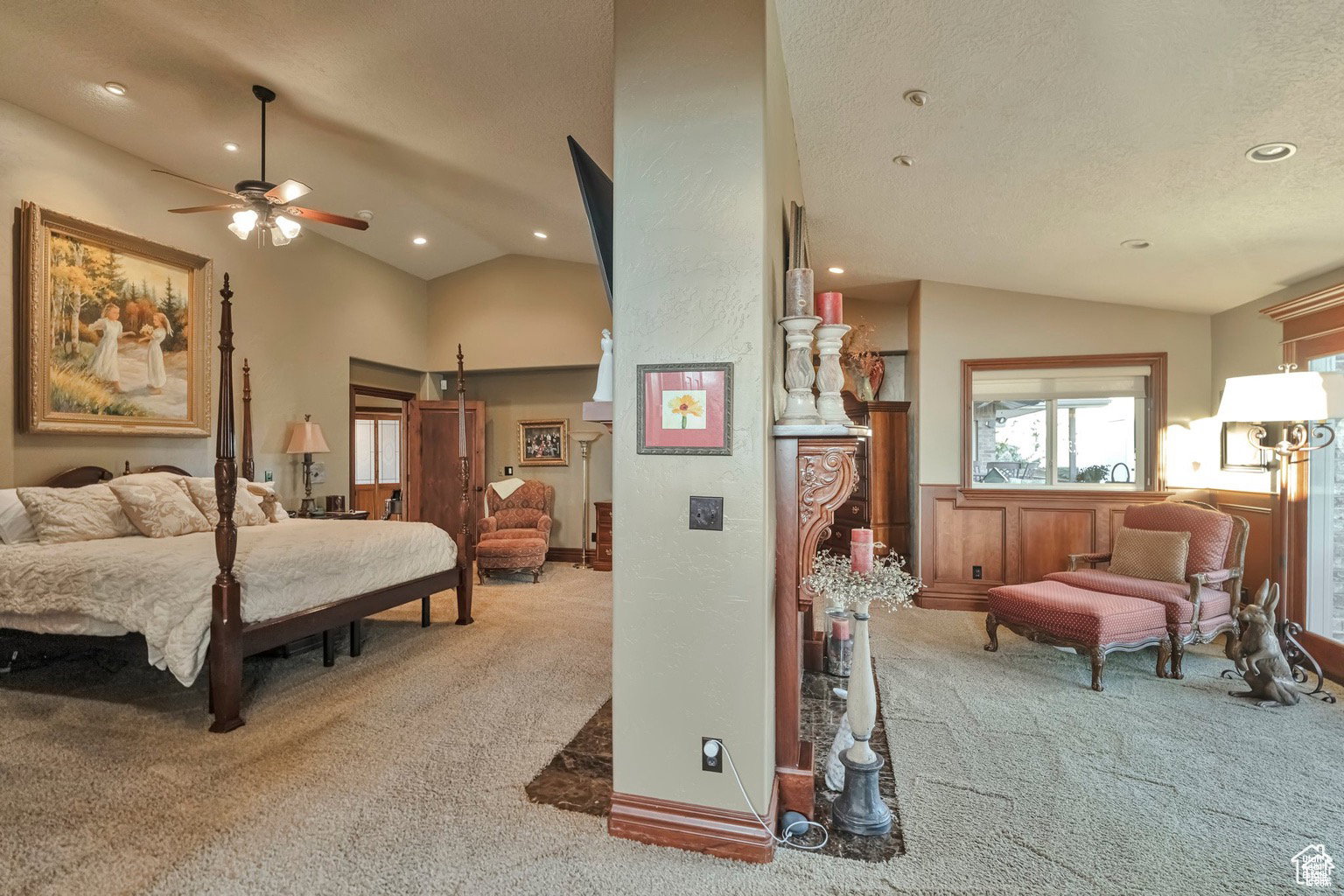 Bedroom featuring light colored carpet, lofted ceiling, recessed lighting, and wainscoting