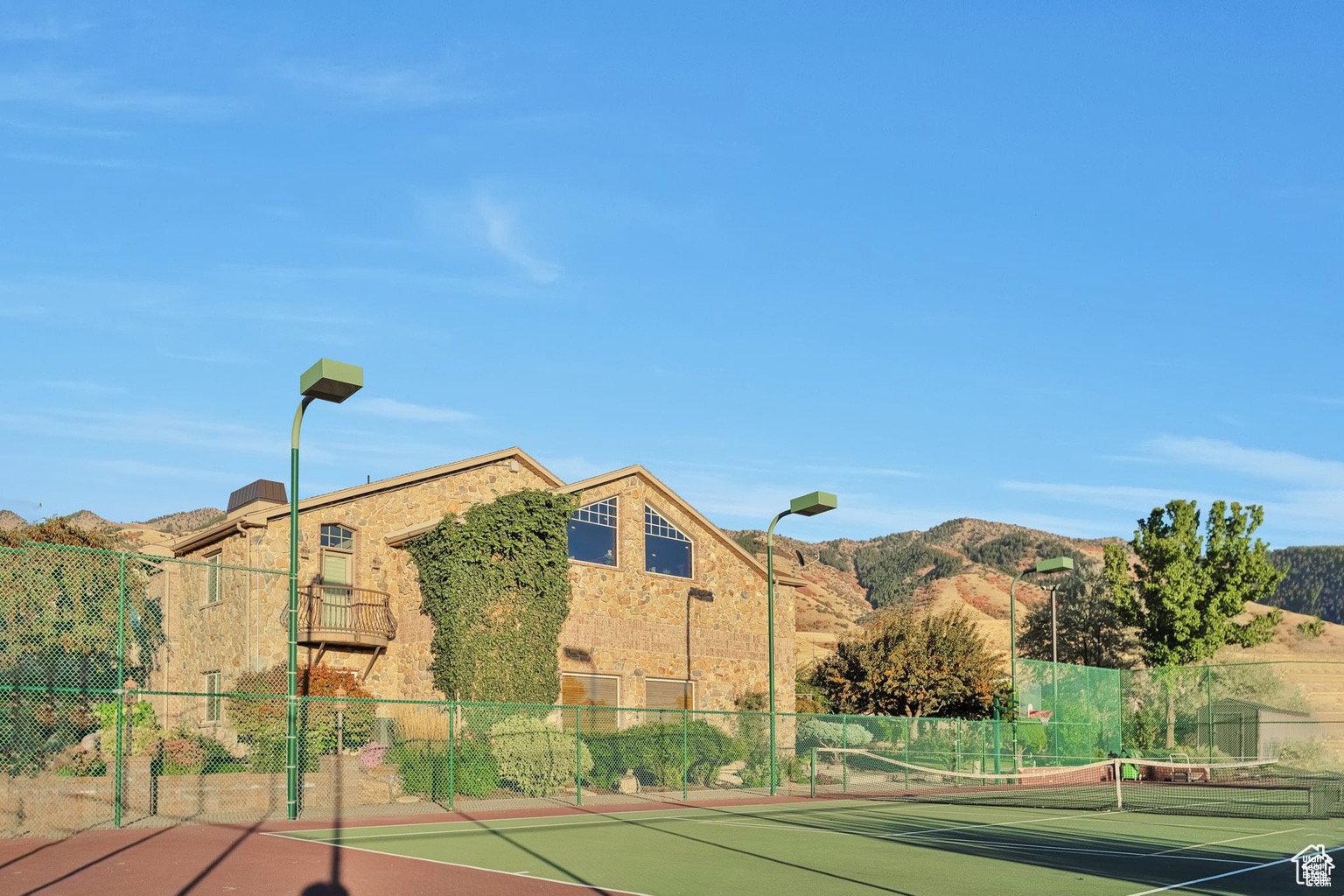 View of tennis court featuring a mountain view