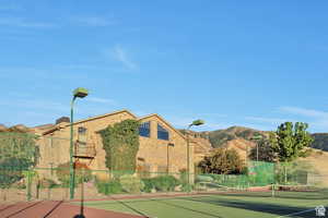 View of tennis court featuring a mountain view