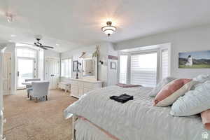 Bedroom with light colored carpet and a ceiling fan
