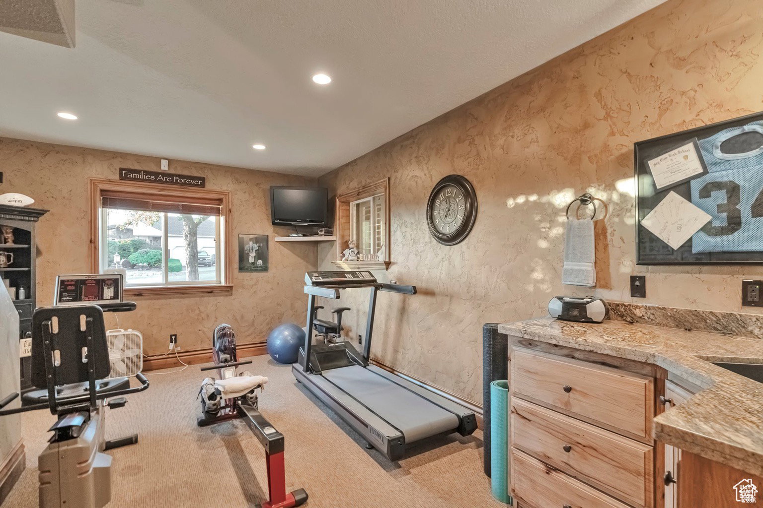 Workout area with recessed lighting and wallpapered walls