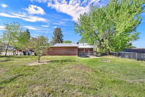 Back of property with brick siding and a deck