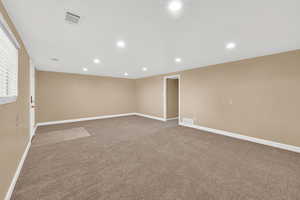 Spare room featuring light carpet and recessed lighting