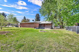 Back of property with brick siding and covered porch