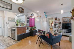 Living area featuring vaulted ceiling and recessed lighting