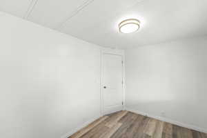 Unfurnished room featuring light wood-style flooring and crown molding