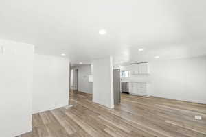 Unfurnished living room with light wood-style floors and recessed lighting