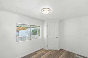 Empty room with wood finished floors and crown molding