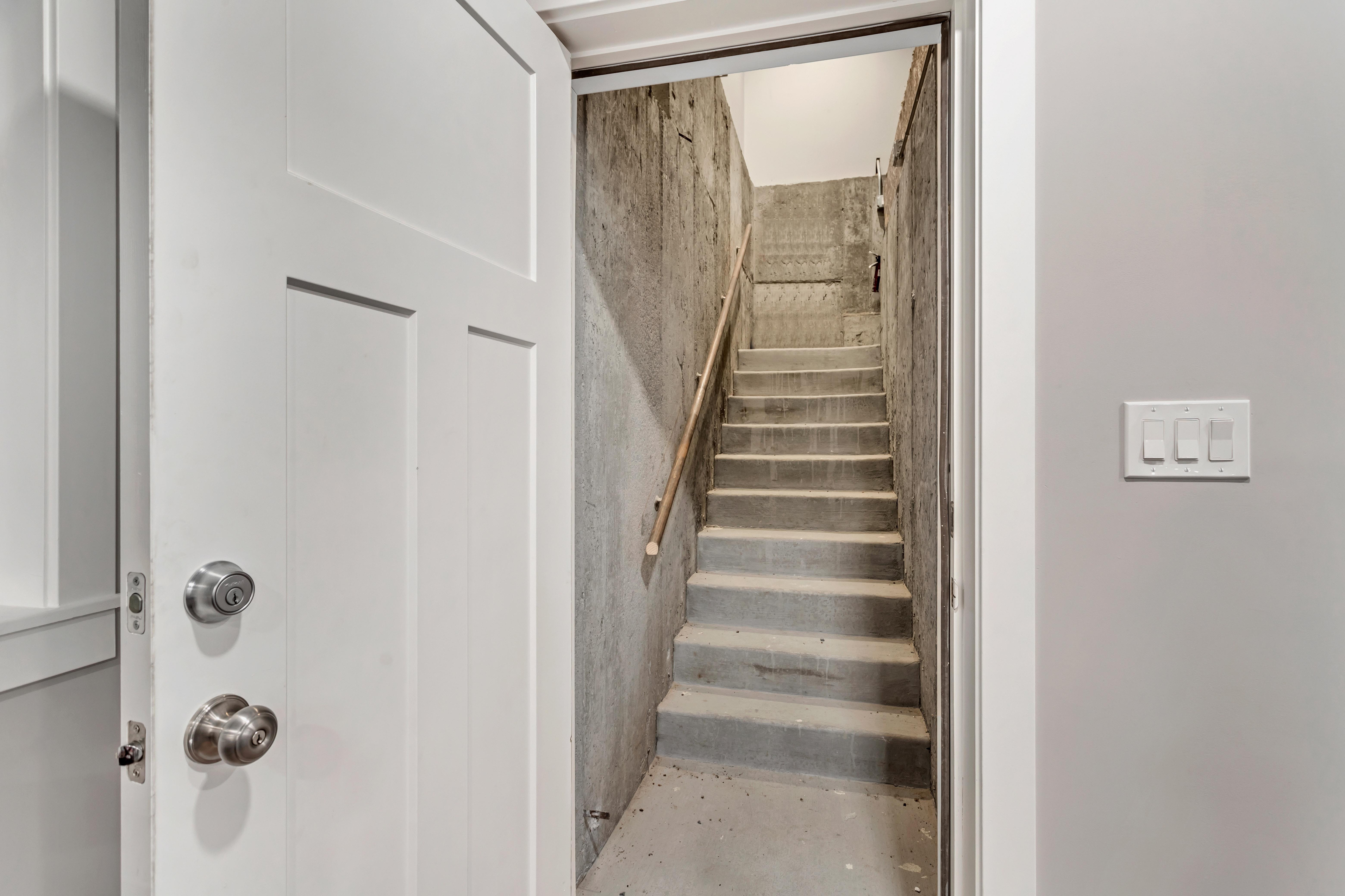 Staircase with unfinished concrete floors