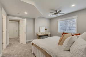Bedroom with light carpet, ceiling fan, and recessed lighting