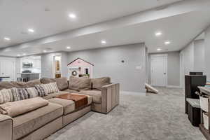 Living area featuring recessed lighting and light carpet