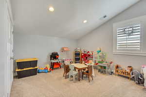 Game room with lofted ceiling, recessed lighting, and light carpet