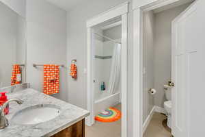 Full bathroom featuring vanity, shower / bath combo, and light wood-style flooring