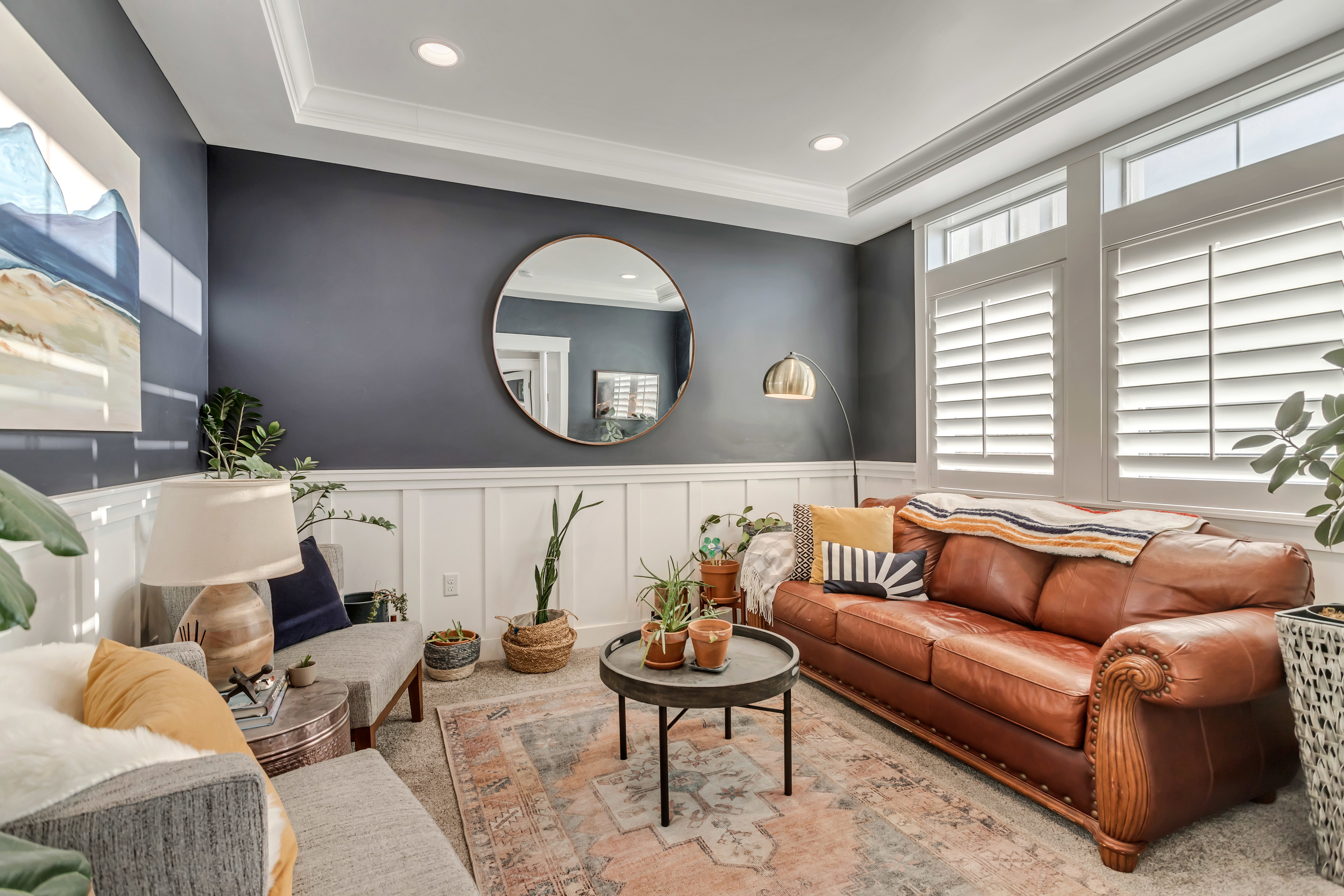 Carpeted living room featuring wainscoting, recessed lighting, ornamental molding, and a decorative wall