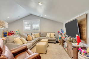 Living area featuring light carpet and recessed lighting