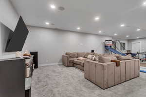 Living room with light colored carpet and recessed lighting