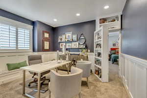 Office area with a decorative wall, a wainscoted wall, light colored carpet, and recessed lighting