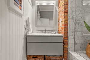 Bathroom featuring ornamental molding and vanity