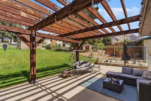 View of patio / terrace with outdoor seating, a pergola, and a shed