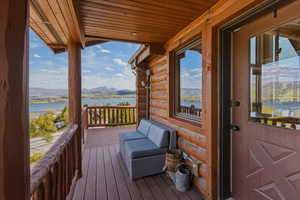 Deck with a water and mountain view