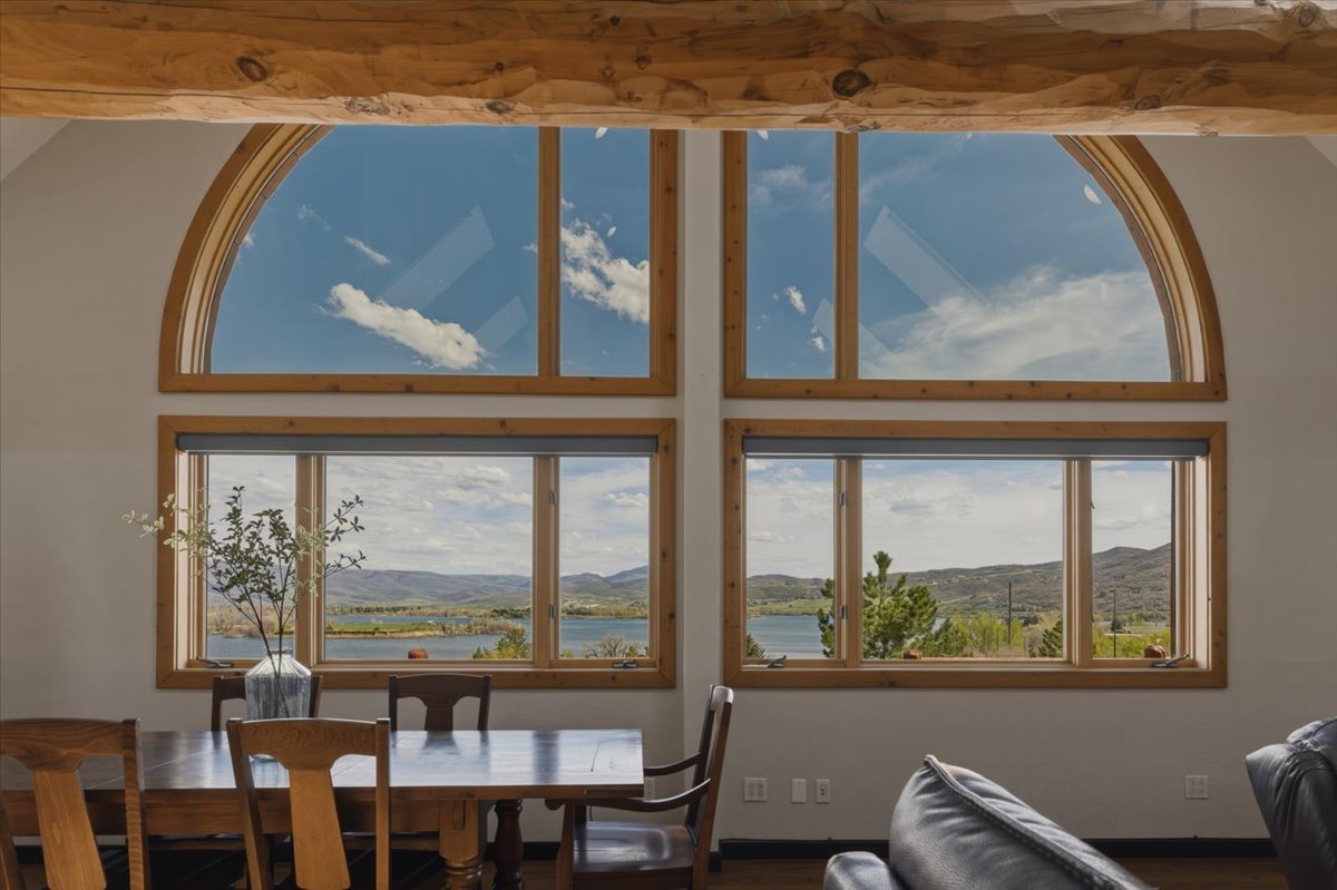 Dining area with a water and mountain view and wood finished floors