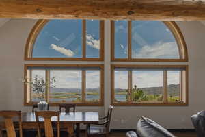 Dining area with a water and mountain view and wood finished floors