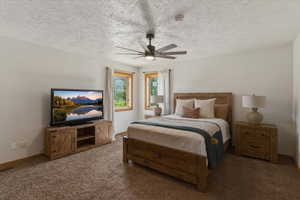 Carpeted bedroom with a textured ceiling and a ceiling fan