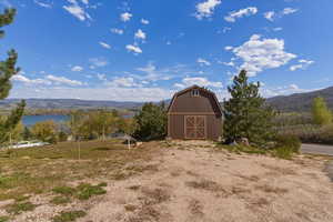 View of barn with a water and mountain view