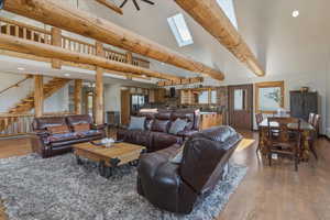 Living room featuring recessed lighting, light wood-type flooring, and vaulted ceiling