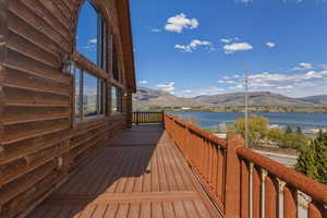 Wooden deck featuring a water and mountain view