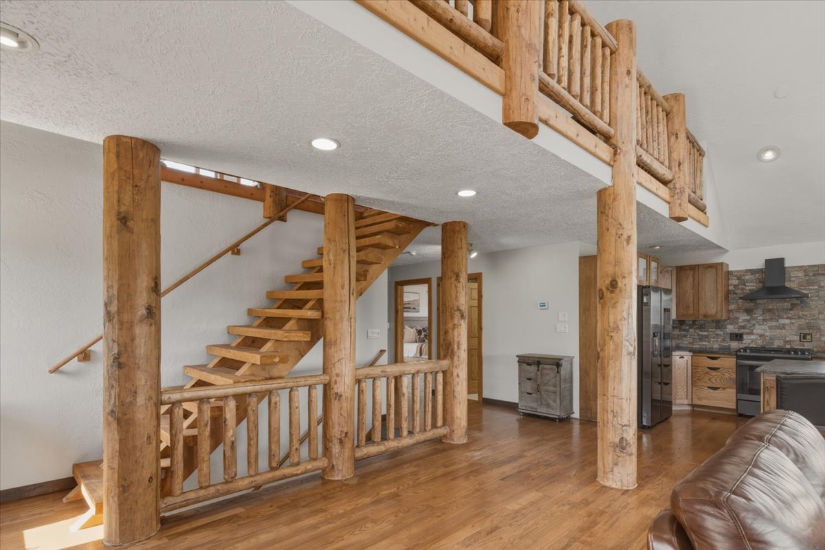 Stairway featuring wood finished floors and recessed lighting