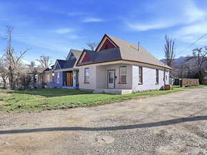 View of home's exterior with covered porch, driveway, and brick siding