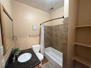 Bathroom with vanity and shower / bath combo with shower curtain