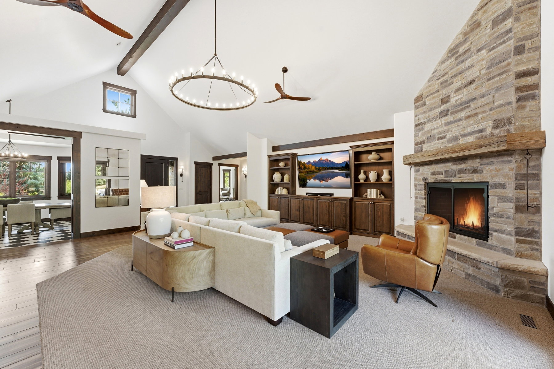 Living area featuring ceiling fan, a chandelier, and built in shelves