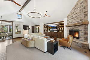 Living area featuring ceiling fan, a chandelier, and built in shelves