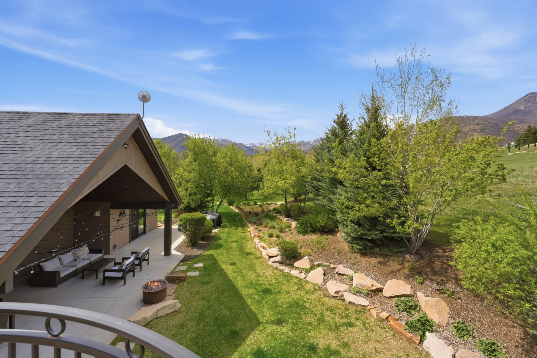 View of grassy yard with a patio, a mountain view, and outdoor lounge area